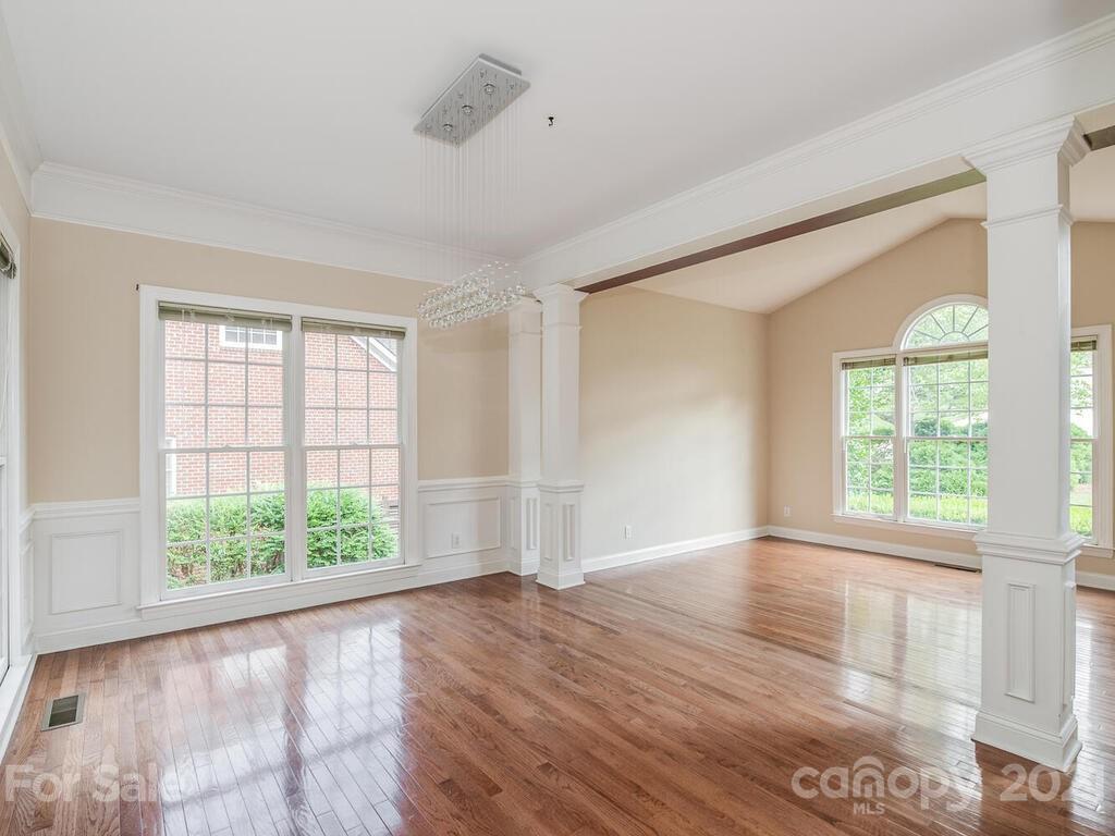 5530 Piper Glen Drive Charlotte, NC 28277 - Photo 6 of 35 a view of an empty room with wooden floor and a window