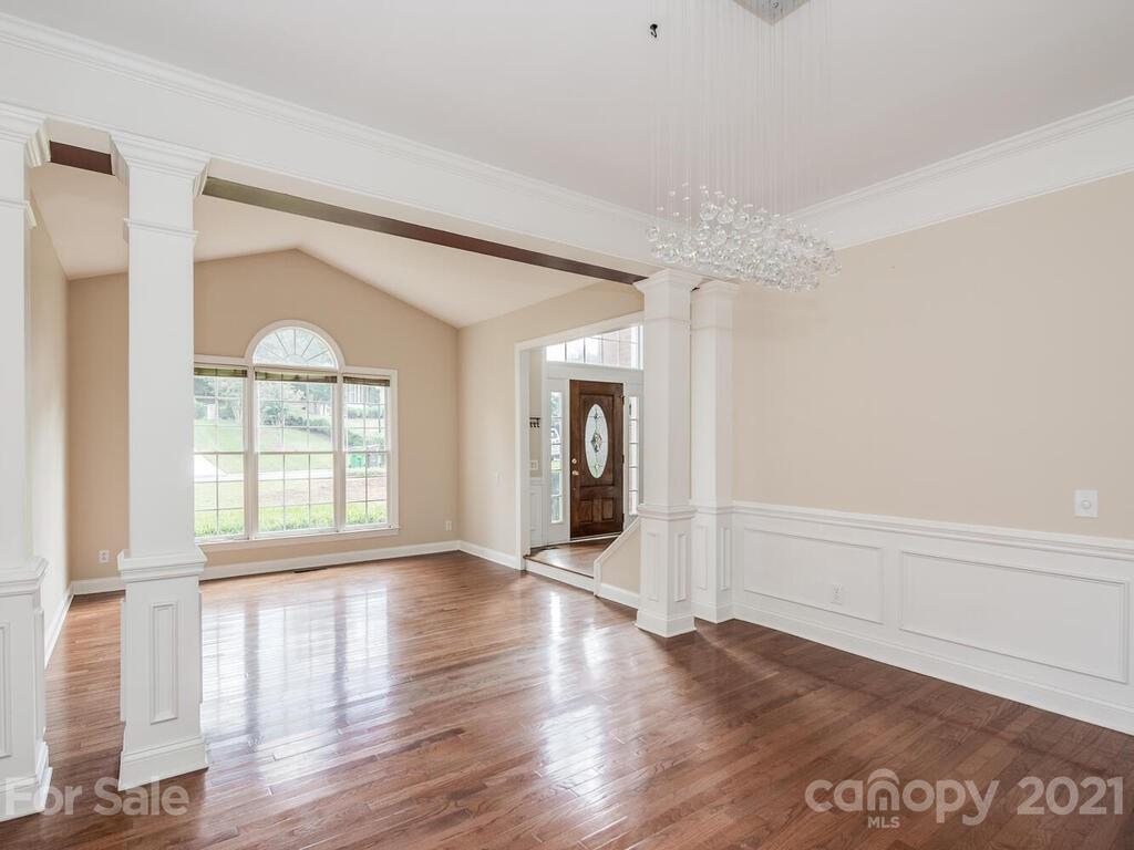 5530 Piper Glen Drive Charlotte, NC 28277 - Photo 7 of 35 a view of an empty room with wooden floor and a window