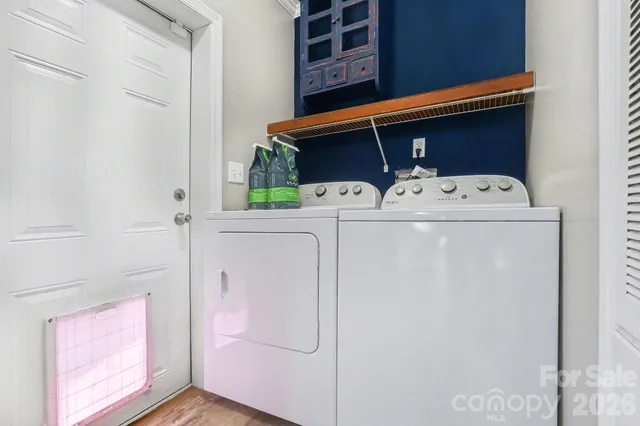 a view of a livingroom with wooden floor and a ceiling fan