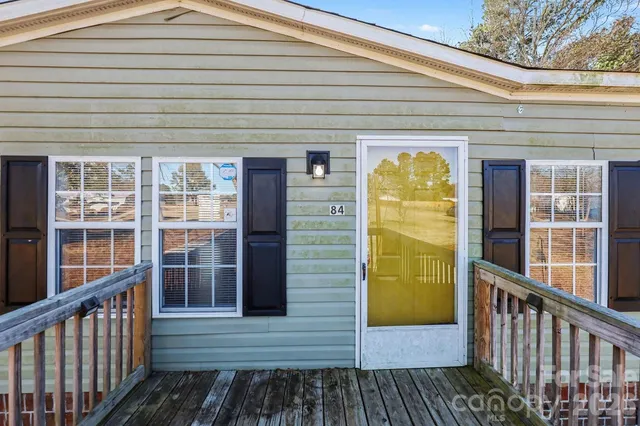 a view of a porch with wooden floor and fence
