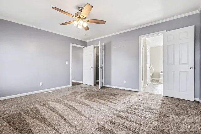 an empty room with a ceiling fan and a bathtub