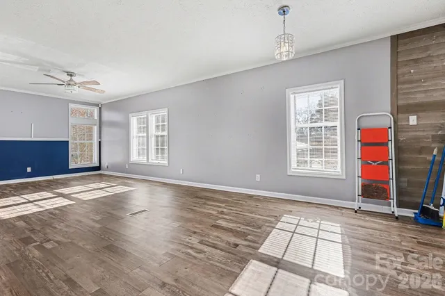 a view of a kitchen with refrigerator and wooden floor