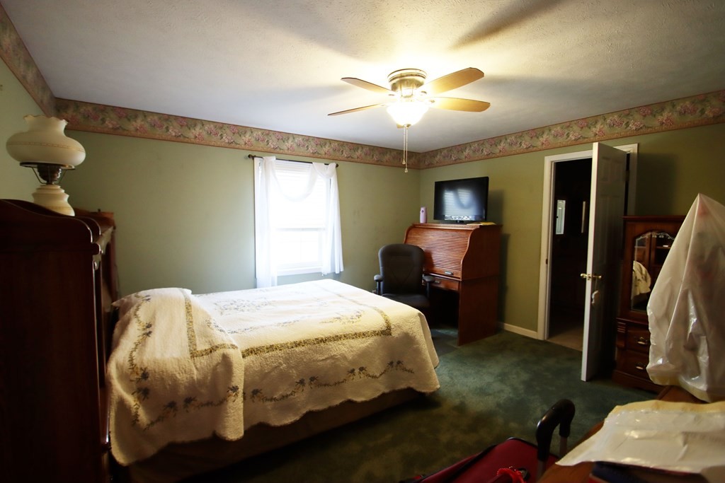 154 Charleston Road Cookeville, TN 38506 - Photo 12 of 23 a bedroom with a bed and a chandelier