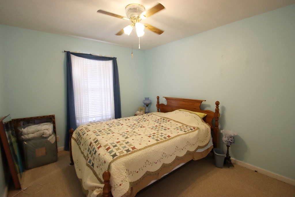 154 Charleston Road Cookeville, TN 38506 - Photo 14 of 23 a bedroom with a bed and a chandelier