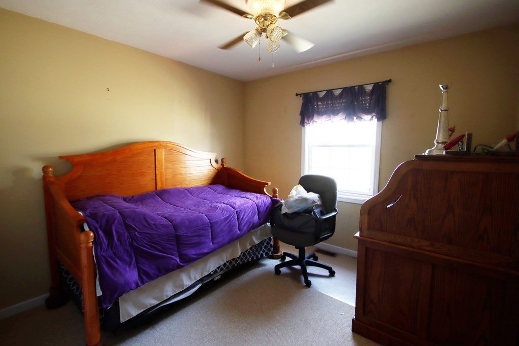 154 Charleston Road Cookeville, TN 38506 - Photo 16 of 23 a bedroom with a bed and a chandelier
