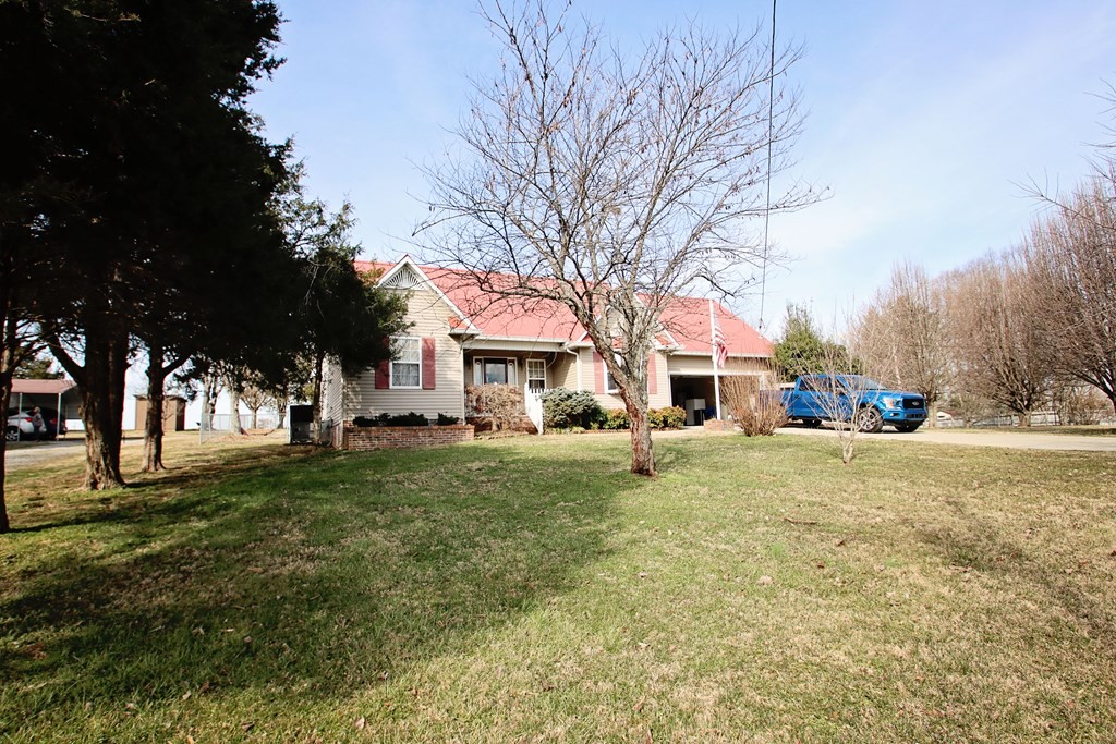 154 Charleston Road Cookeville, TN 38506 - Photo 2 of 23 a view of a yard with a house and a trees in the background