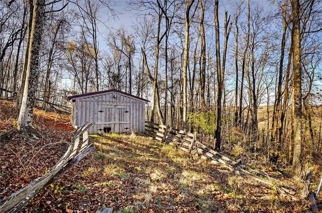 a view of a house with snow on the side of the road