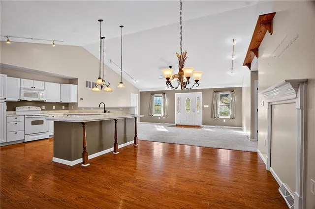 a view of a kitchen with a sink stainless steel appliances and cabinets