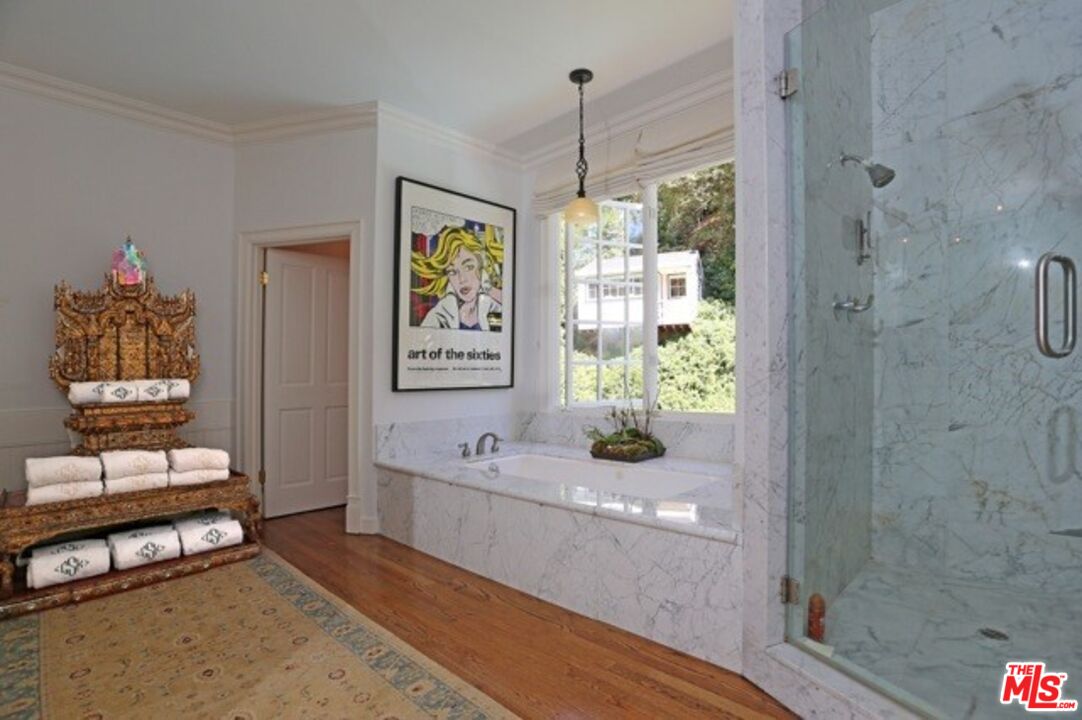 914 Chantilly Road Los Angeles, CA 90077 - Photo 21 of 25 a bathroom with a tub shower and window