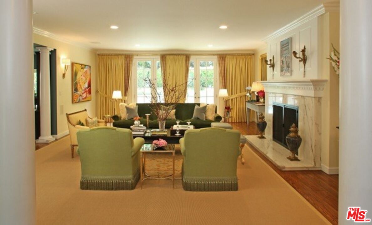 914 Chantilly Road Los Angeles, CA 90077 - Photo 8 of 25 a living room with furniture a large window and a fireplace
