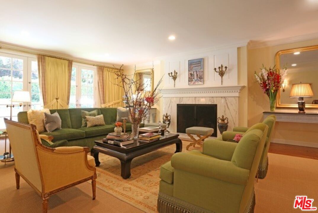 914 Chantilly Road Los Angeles, CA 90077 - Photo 9 of 25 a living room with furniture and a fireplace