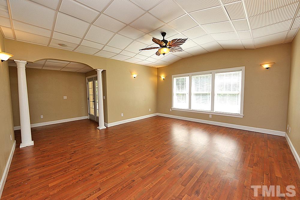5214 Landguard Drive Raleigh, NC 27613 - Photo 16 of 20 a view of empty room with wooden floor and fan