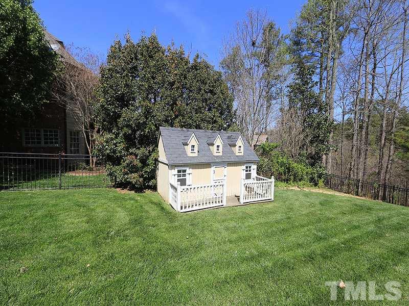 5214 Landguard Drive Raleigh, NC 27613 - Photo 20 of 20 a view of a wooden fence and a bench in the garden