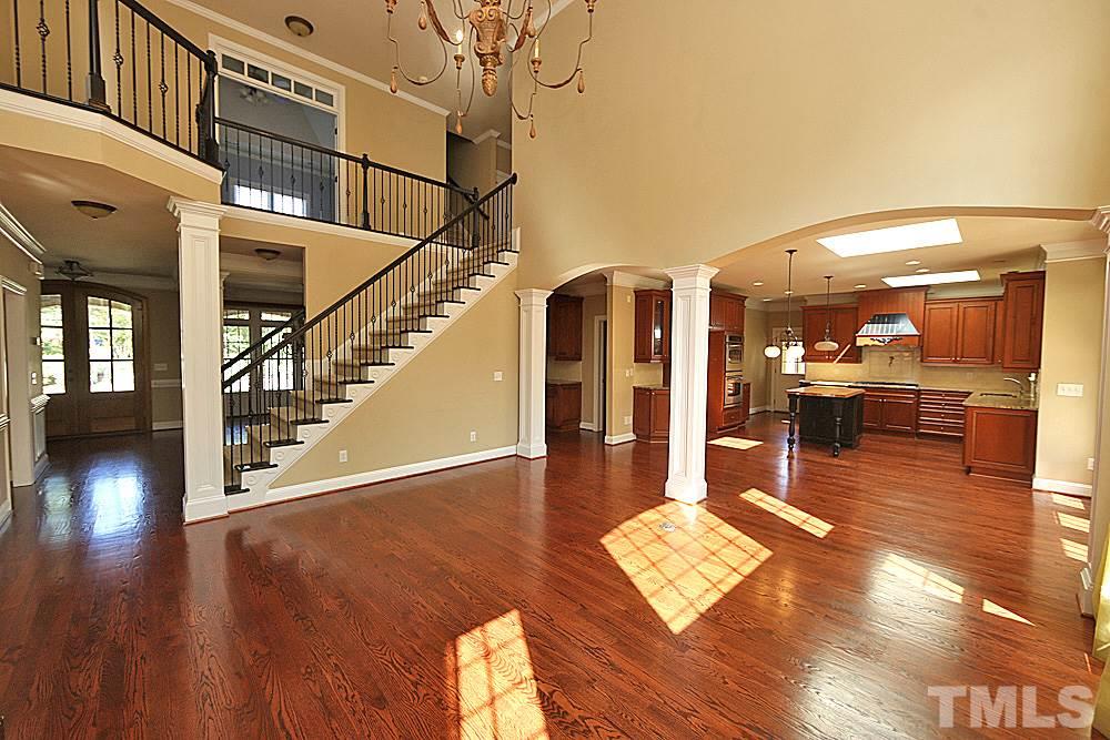 5214 Landguard Drive Raleigh, NC 27613 - Photo 4 of 20 a view of a living room with kitchen view and a wooden floor