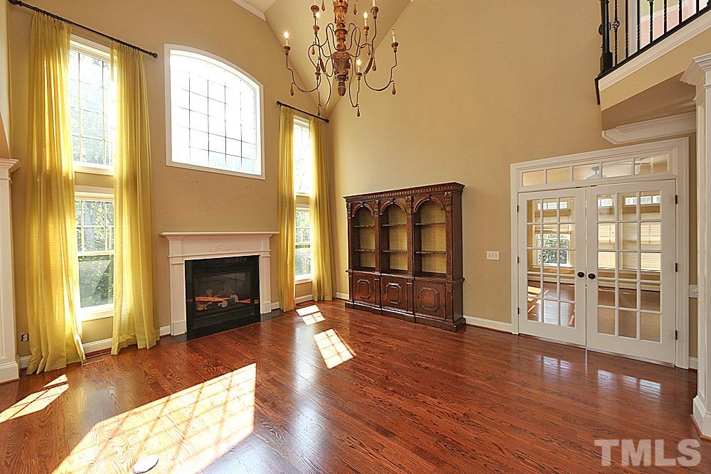 5214 Landguard Drive Raleigh, NC 27613 - Photo 5 of 20 a living room with hard wood floors and a fireplace