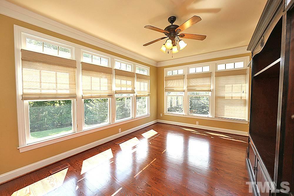 5214 Landguard Drive Raleigh, NC 27613 - Photo 8 of 20 a view of an empty room with wooden floor and a window