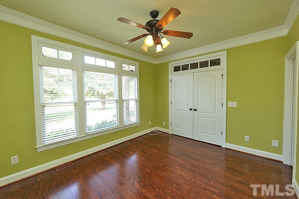 5214 Landguard Drive Raleigh, NC 27613 - Photo 10 of 20 a view of an empty room with window and wooden floor