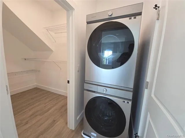 an empty room with wooden floor and natural light