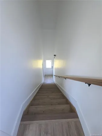 a large kitchen with a refrigerator a sink and dishwasher wooden cabinets with wooden floor