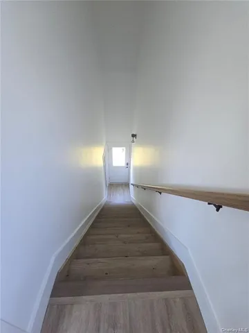 a large kitchen with a refrigerator a sink and dishwasher wooden cabinets with wooden floor