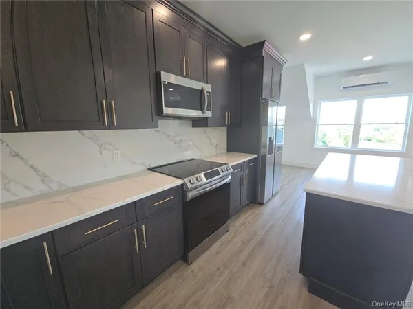 a kitchen with stainless steel appliances granite countertop a sink and a stove top oven
