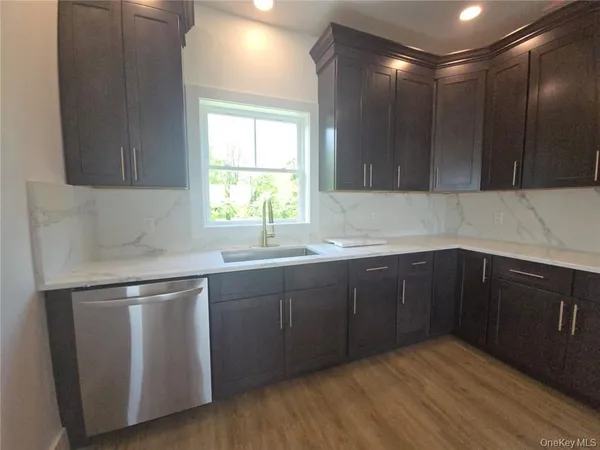 a kitchen with wooden cabinets and sink