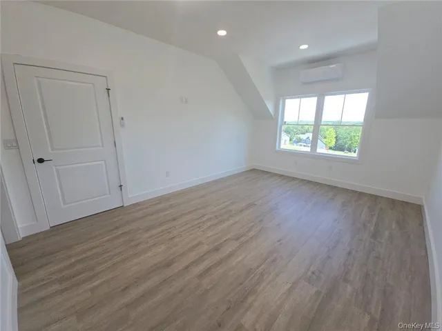 a view of kitchen with kitchen island wooden floor appliances and living room