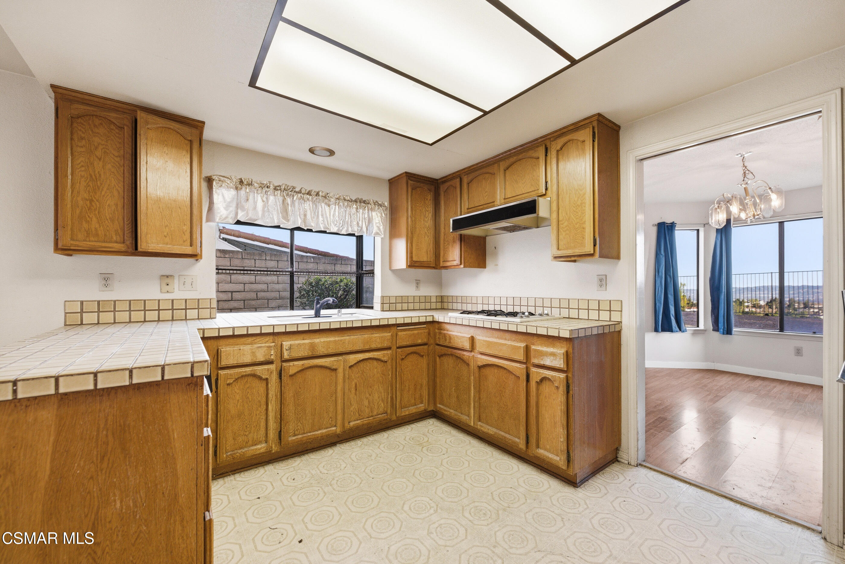 12036 Shadow Ridge Way Porter Ranch, CA 91326 - Photo 17 of 35 a kitchen with stainless steel appliances granite countertop a sink stove and refrigerator