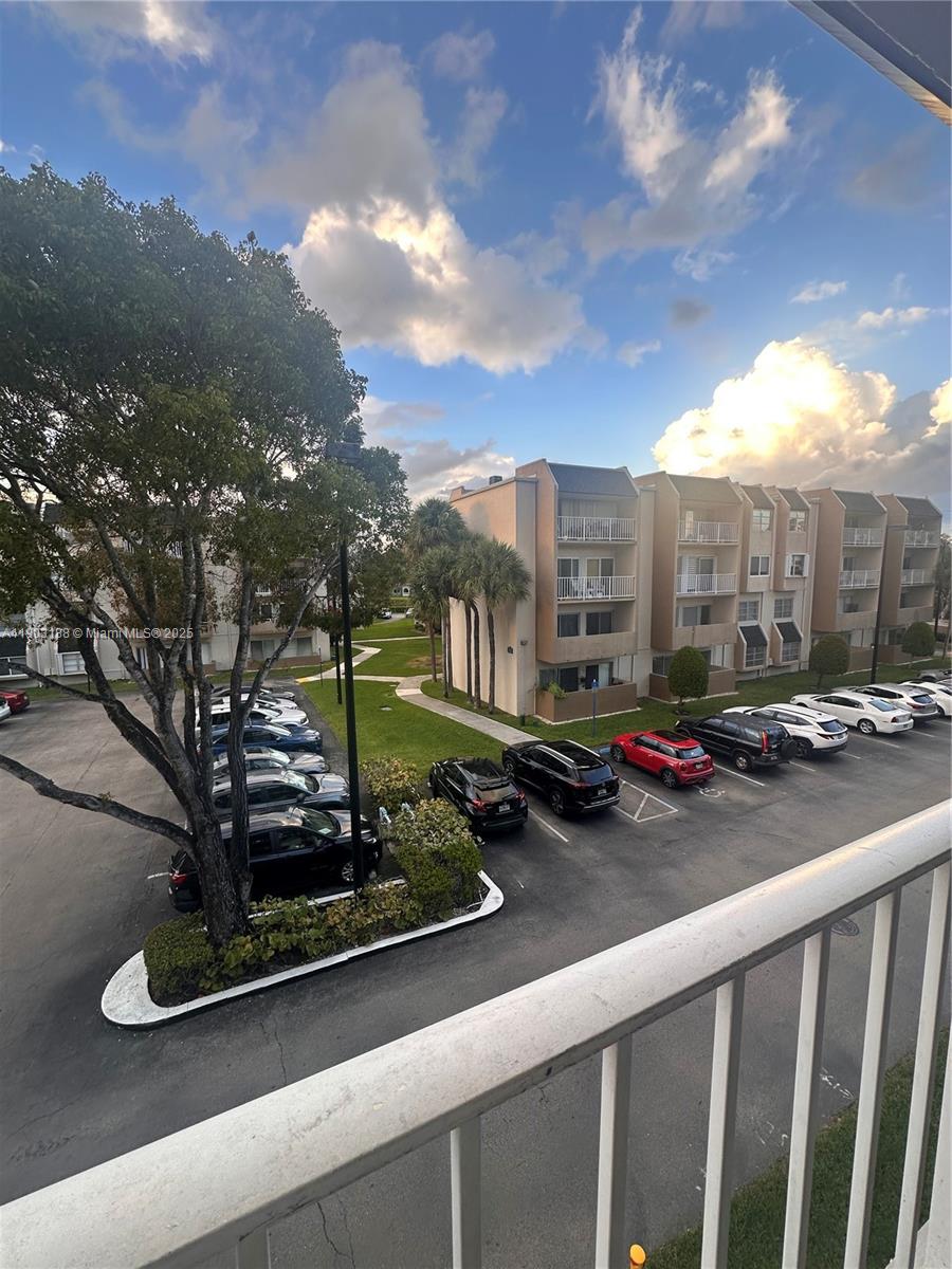 7705 Southwest 86th Street, Unit B315 Miami, FL 33143 - Photo 22 of 28 a view of a street with cars parked