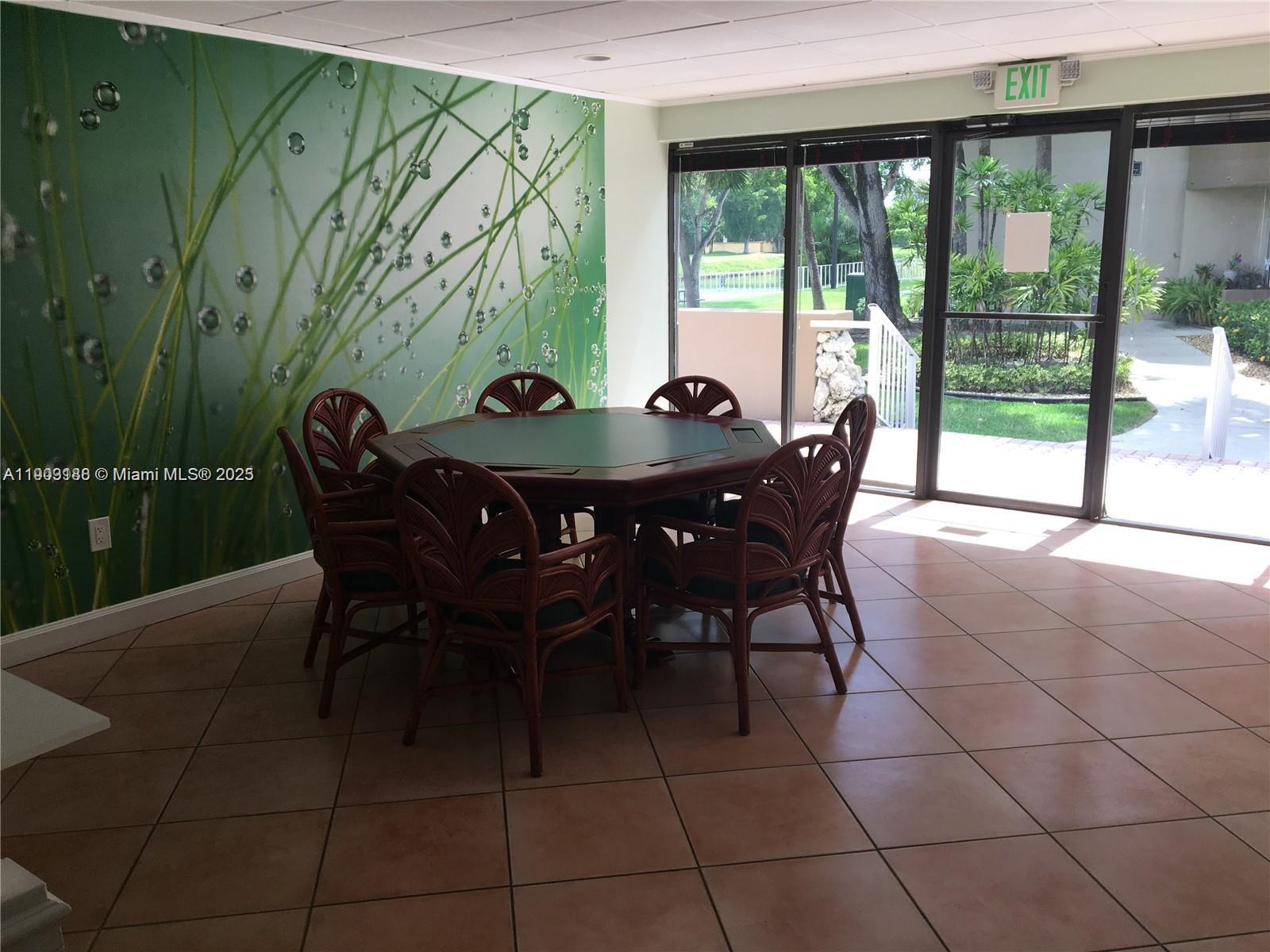 7705 Southwest 86th Street, Unit B315 Miami, FL 33143 - Photo 26 of 28 a view of a dining room with furniture and window