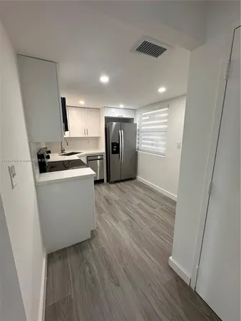 a view of a kitchen with wooden floor