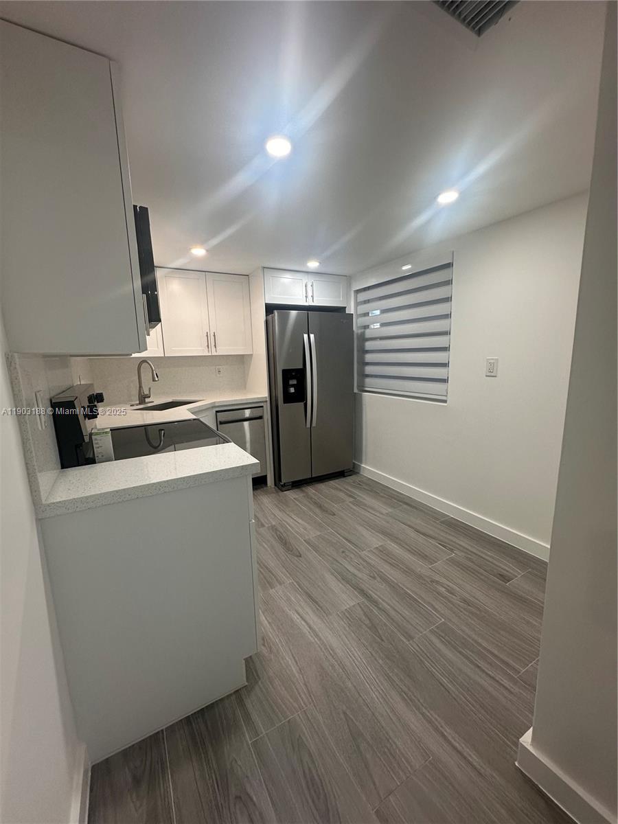 7705 Southwest 86th Street, Unit B315 Miami, FL 33143 - Photo 4 of 28 a view of a kitchen with a sink and a refrigerator