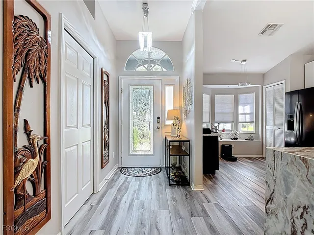 a view of a livingroom with furniture window and wooden floor