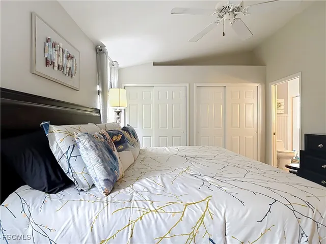 a bedroom with a large bed and a chandelier