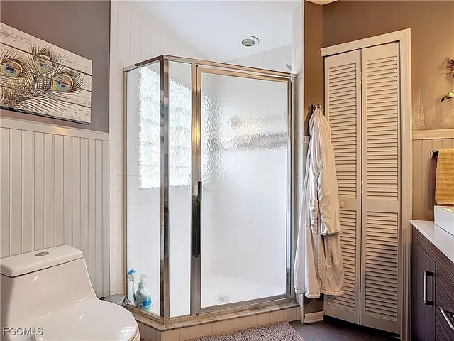 a bathroom with a toilet and a shower curtain