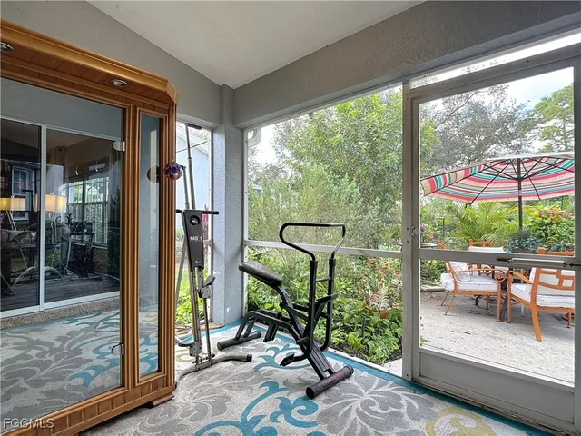 a view of a room with gym equipment and floor to ceiling windows