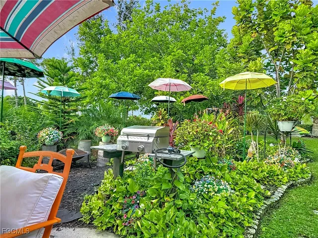 a view of a chairs and table in backyard