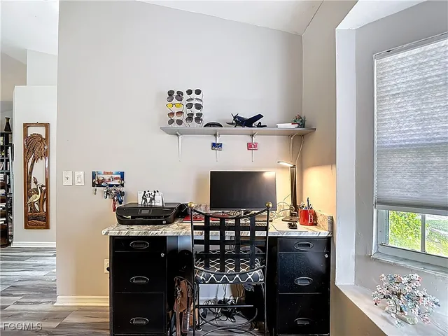 a living room with furniture a flat screen tv and a window