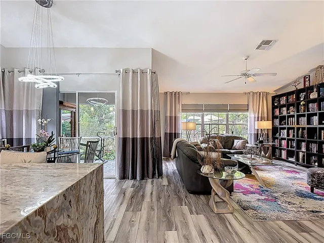 a living room with furniture and large windows