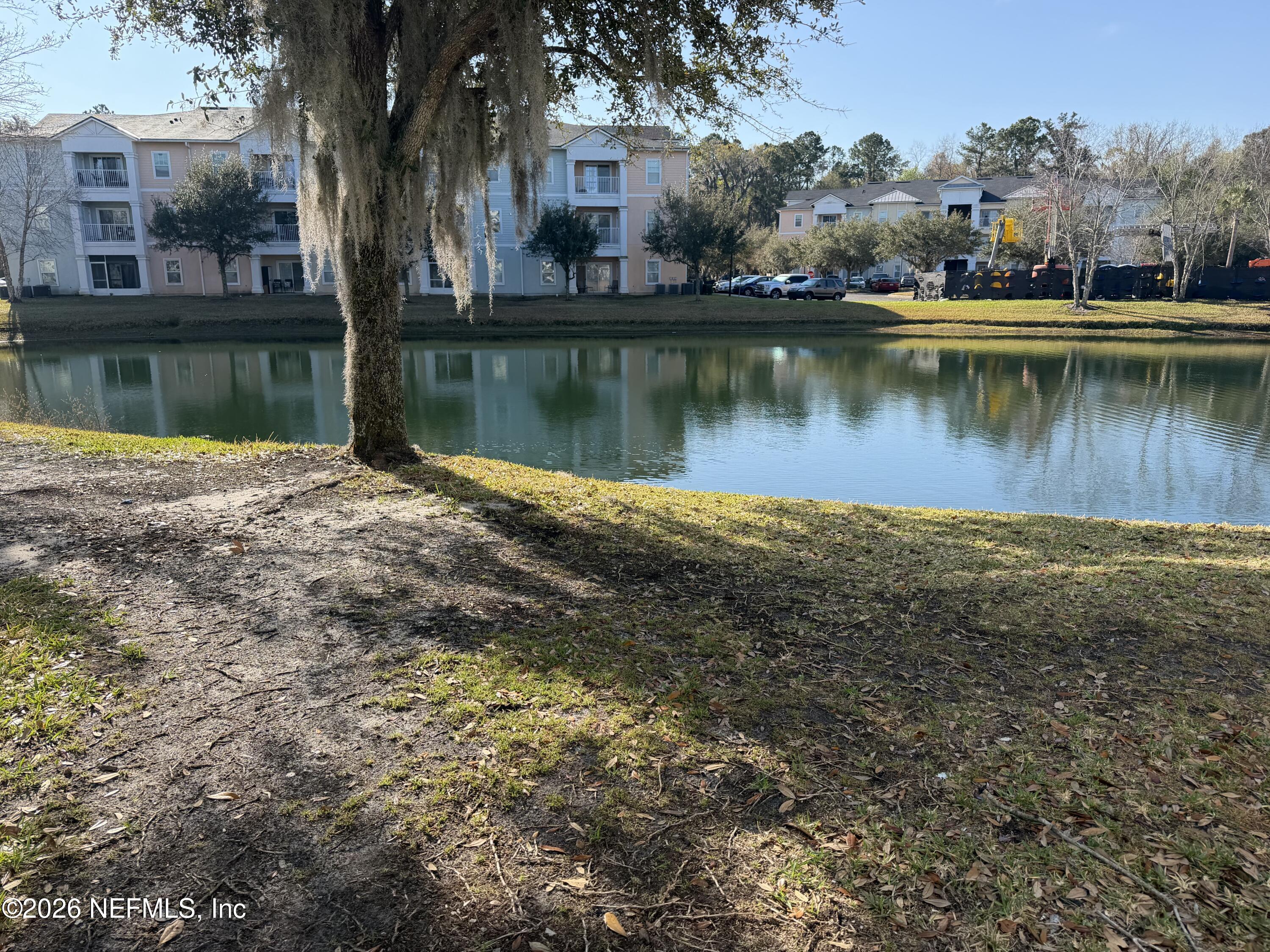 8218 Green Parrot Road, Unit 308 Jacksonville, FL 32256 - Photo 1 of 25 a view of a lake with houses
