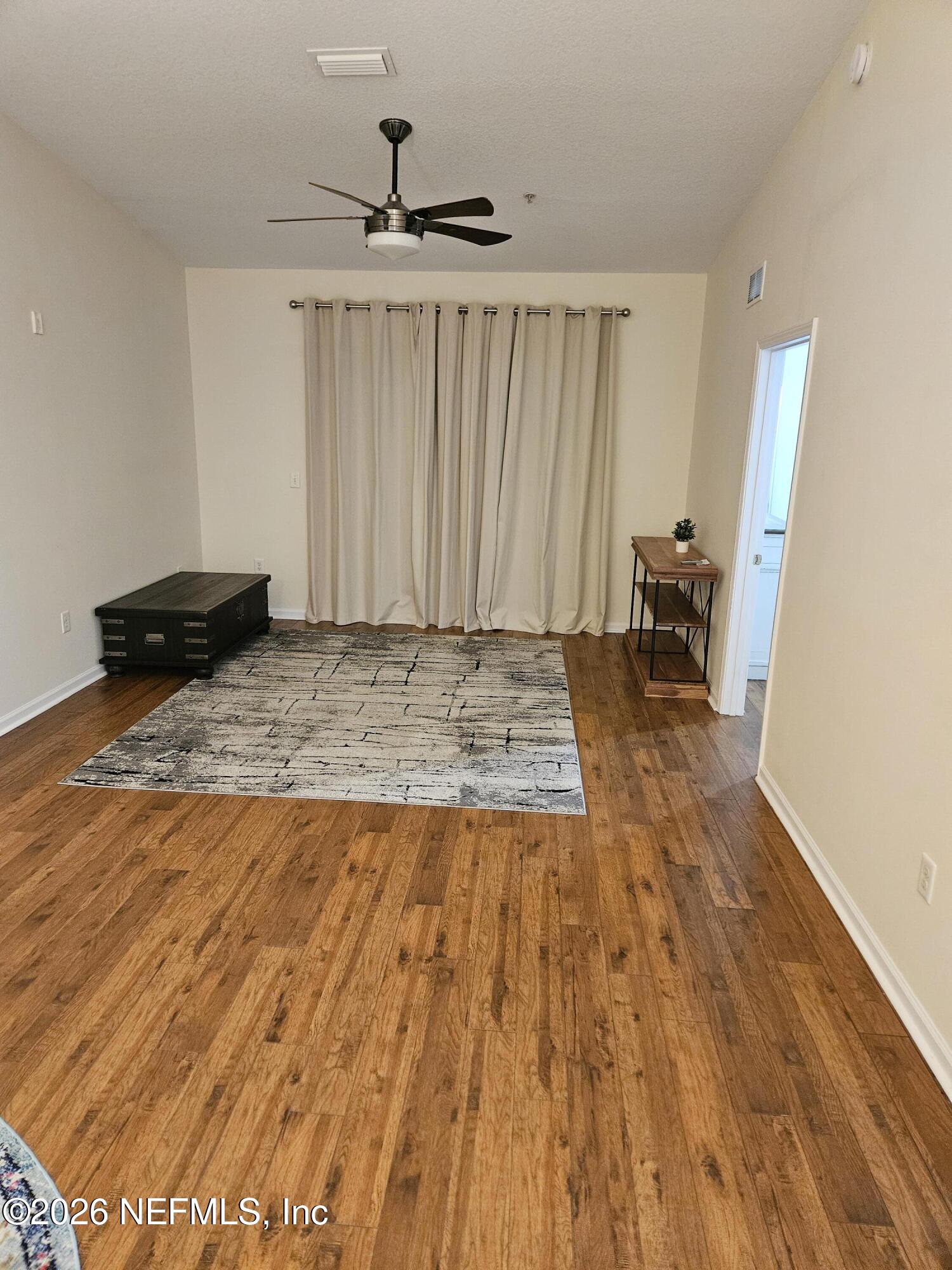 8218 Green Parrot Road, Unit 308 Jacksonville, FL 32256 - Photo 12 of 27 a view of a bedroom with wooden floor and bedroom