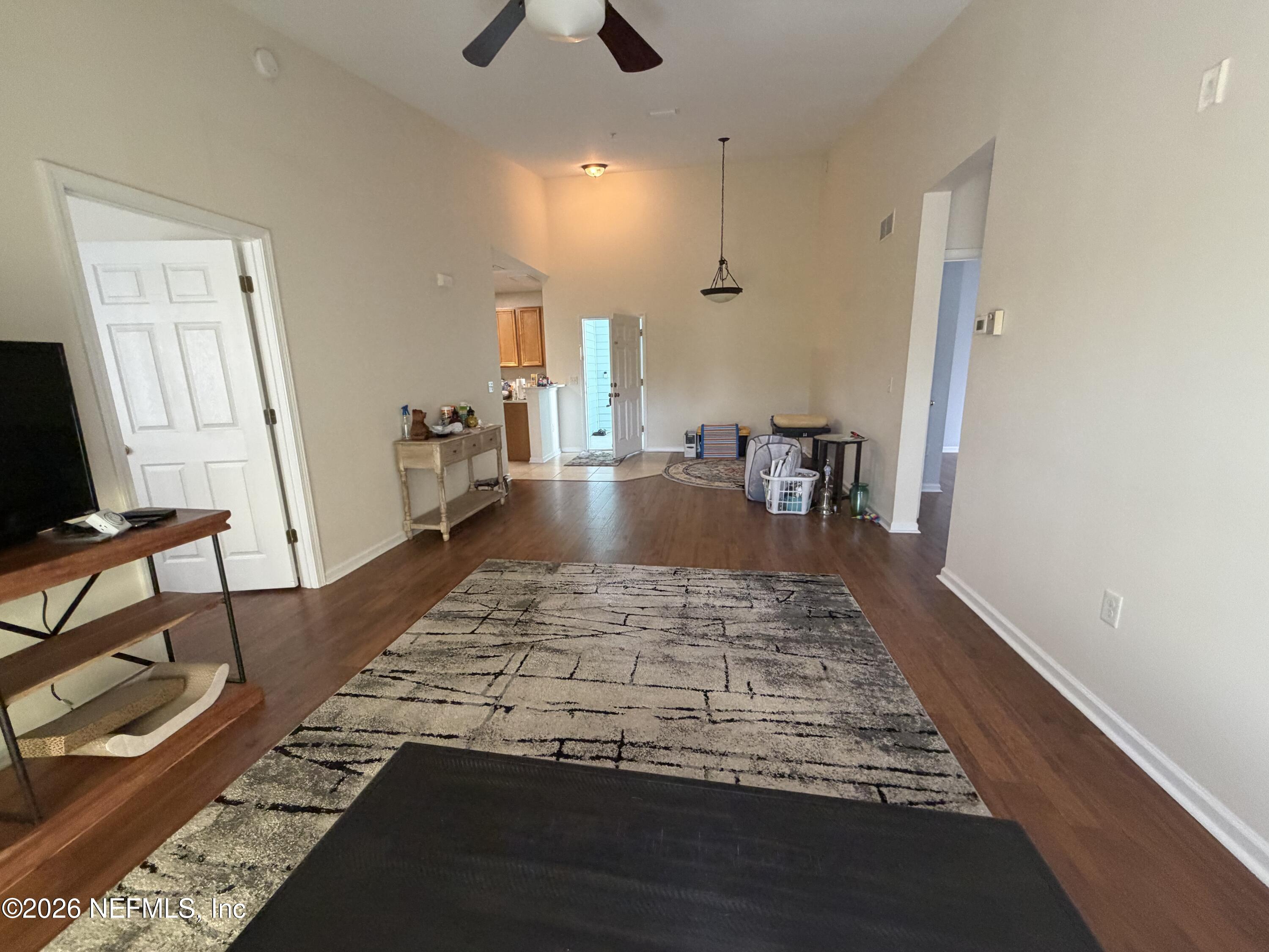 8218 Green Parrot Road, Unit 308 Jacksonville, FL 32256 - Photo 13 of 25 a living room with dining area and a rug