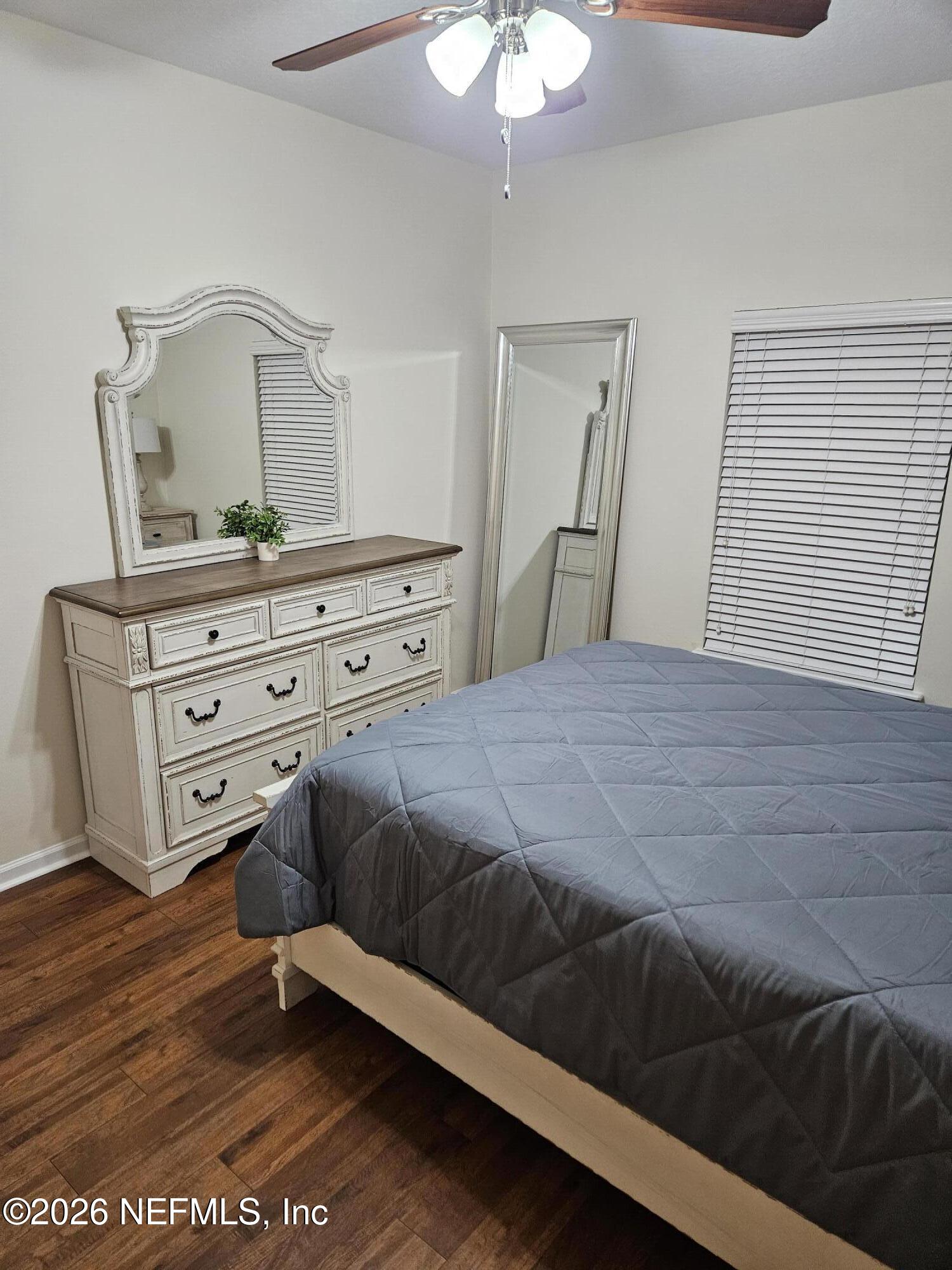 8218 Green Parrot Road, Unit 308 Jacksonville, FL 32256 - Photo 14 of 25 a bedroom with a bed and a dresser