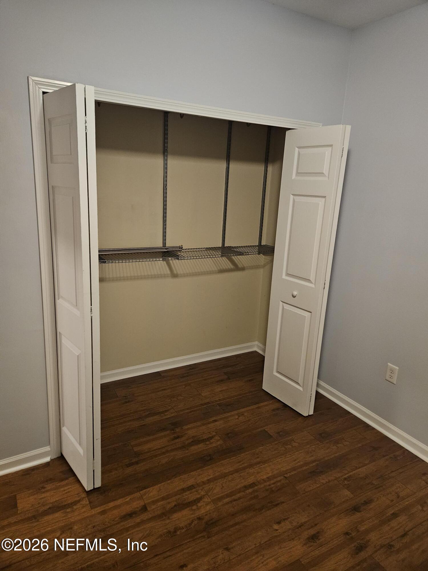 8218 Green Parrot Road, Unit 308 Jacksonville, FL 32256 - Photo 17 of 25 an empty room with wooden floor and closet