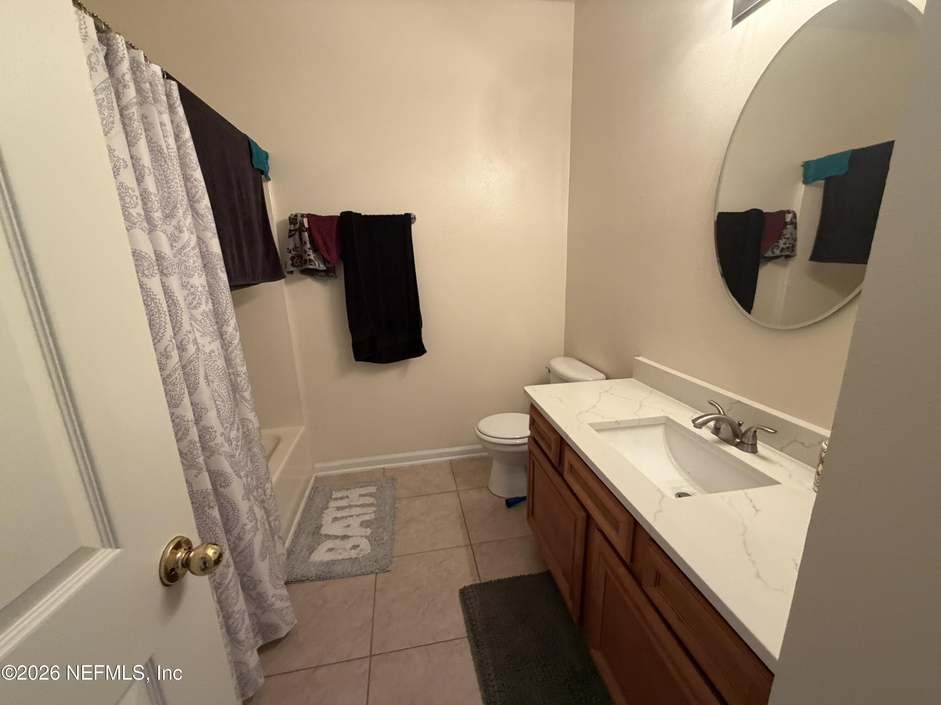 8218 Green Parrot Road, Unit 308 Jacksonville, FL 32256 - Photo 18 of 25 a bathroom with a sink and mirror