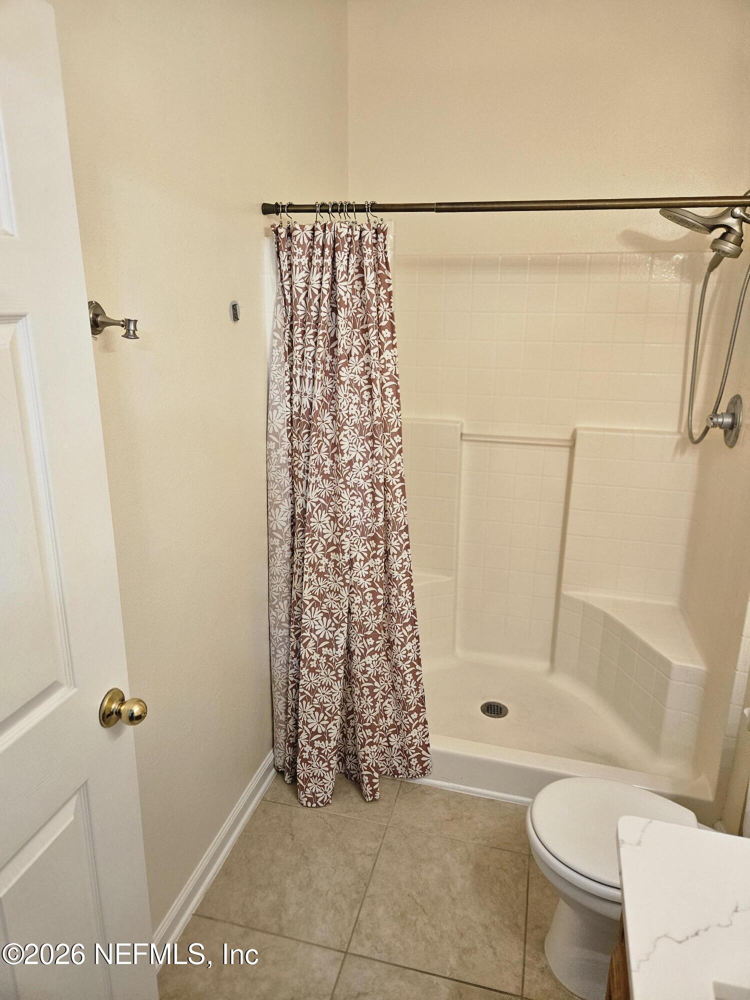8218 Green Parrot Road, Unit 308 Jacksonville, FL 32256 - Photo 19 of 25 a bathroom with a toilet and shower