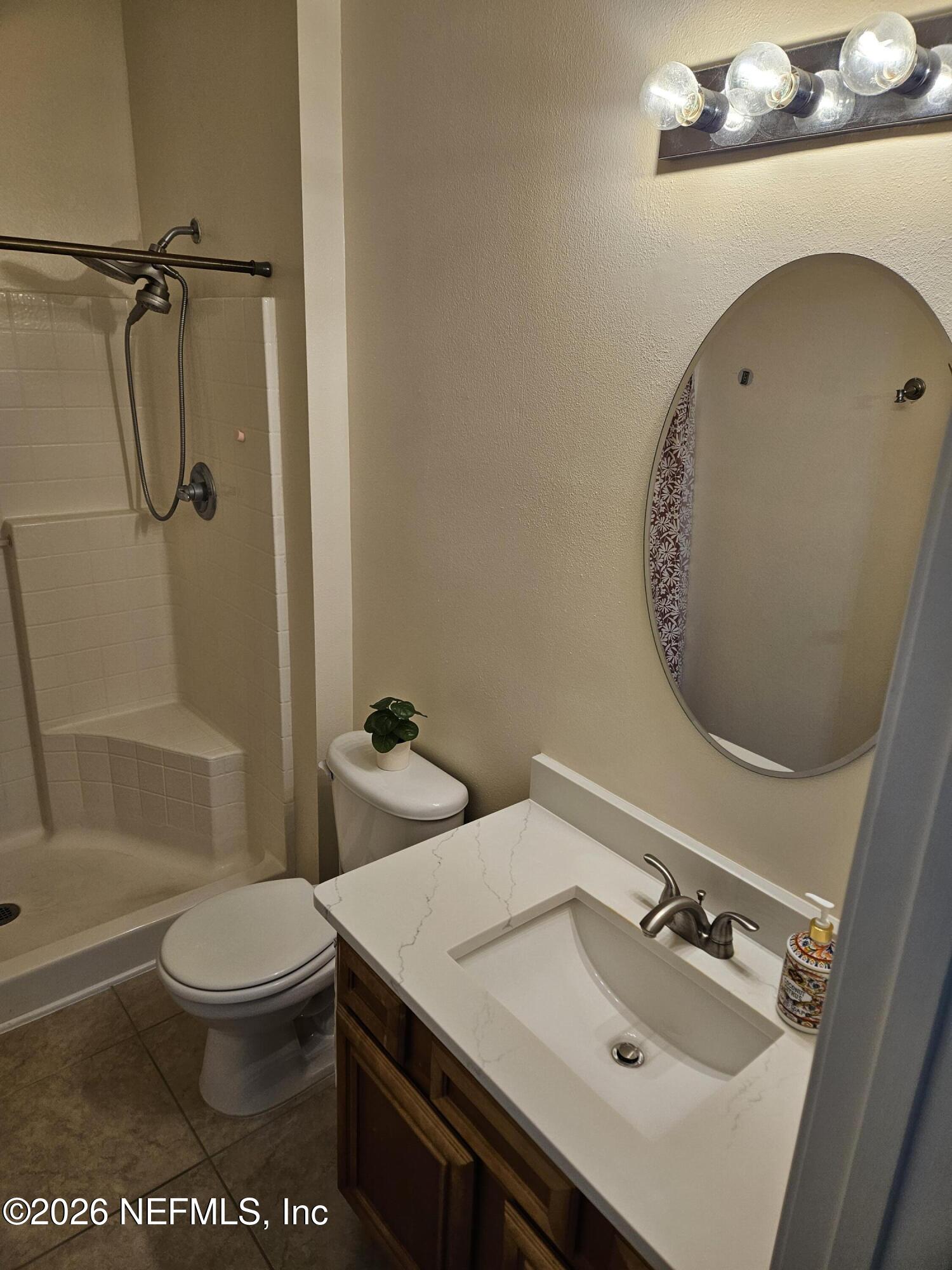 8218 Green Parrot Road, Unit 308 Jacksonville, FL 32256 - Photo 22 of 27 a bathroom with a sink toilet and shower