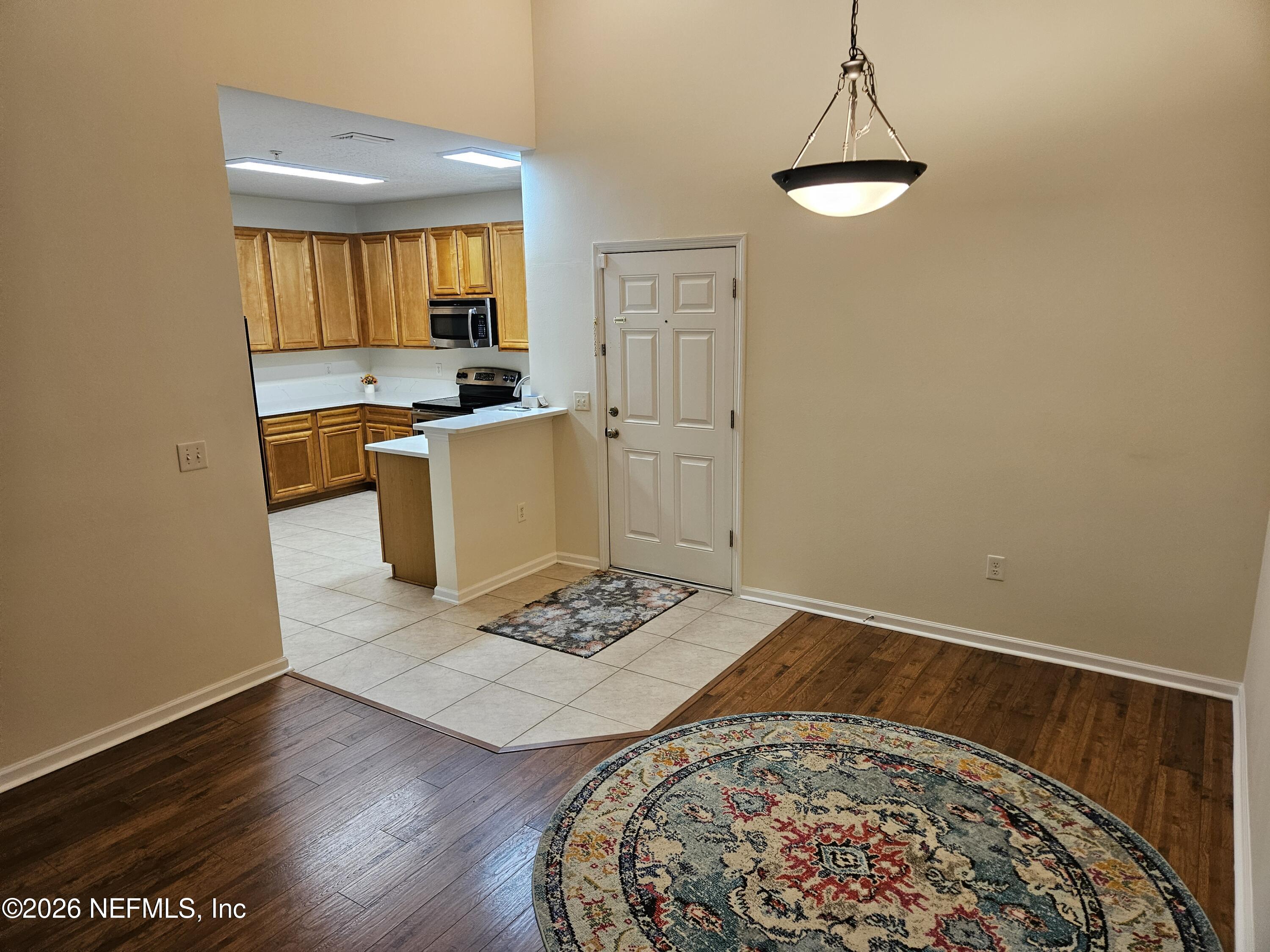 8218 Green Parrot Road, Unit 308 Jacksonville, FL 32256 - Photo 4 of 25 a living room with a couch and a table