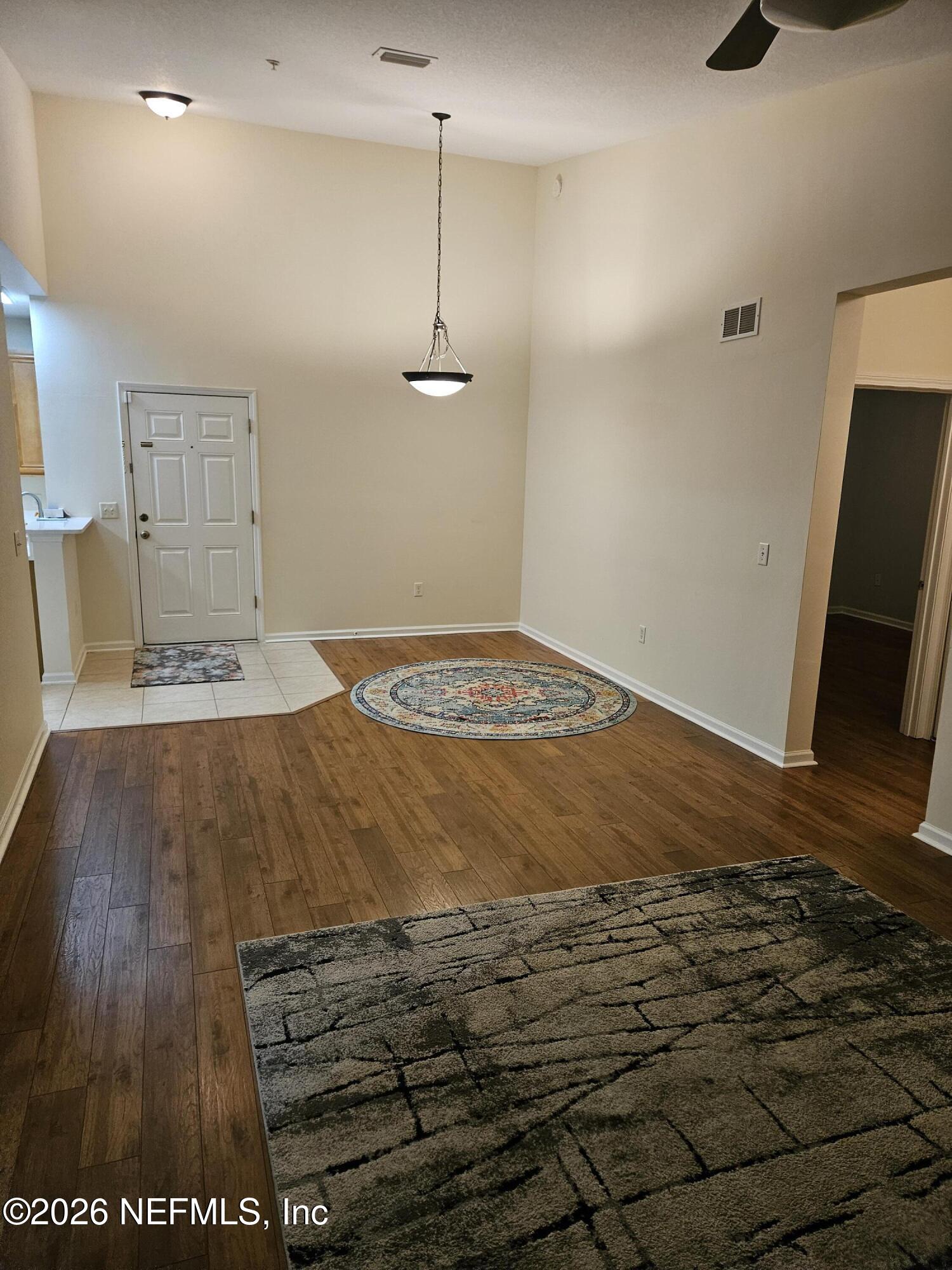 8218 Green Parrot Road, Unit 308 Jacksonville, FL 32256 - Photo 7 of 27 a view of empty room with wooden floor