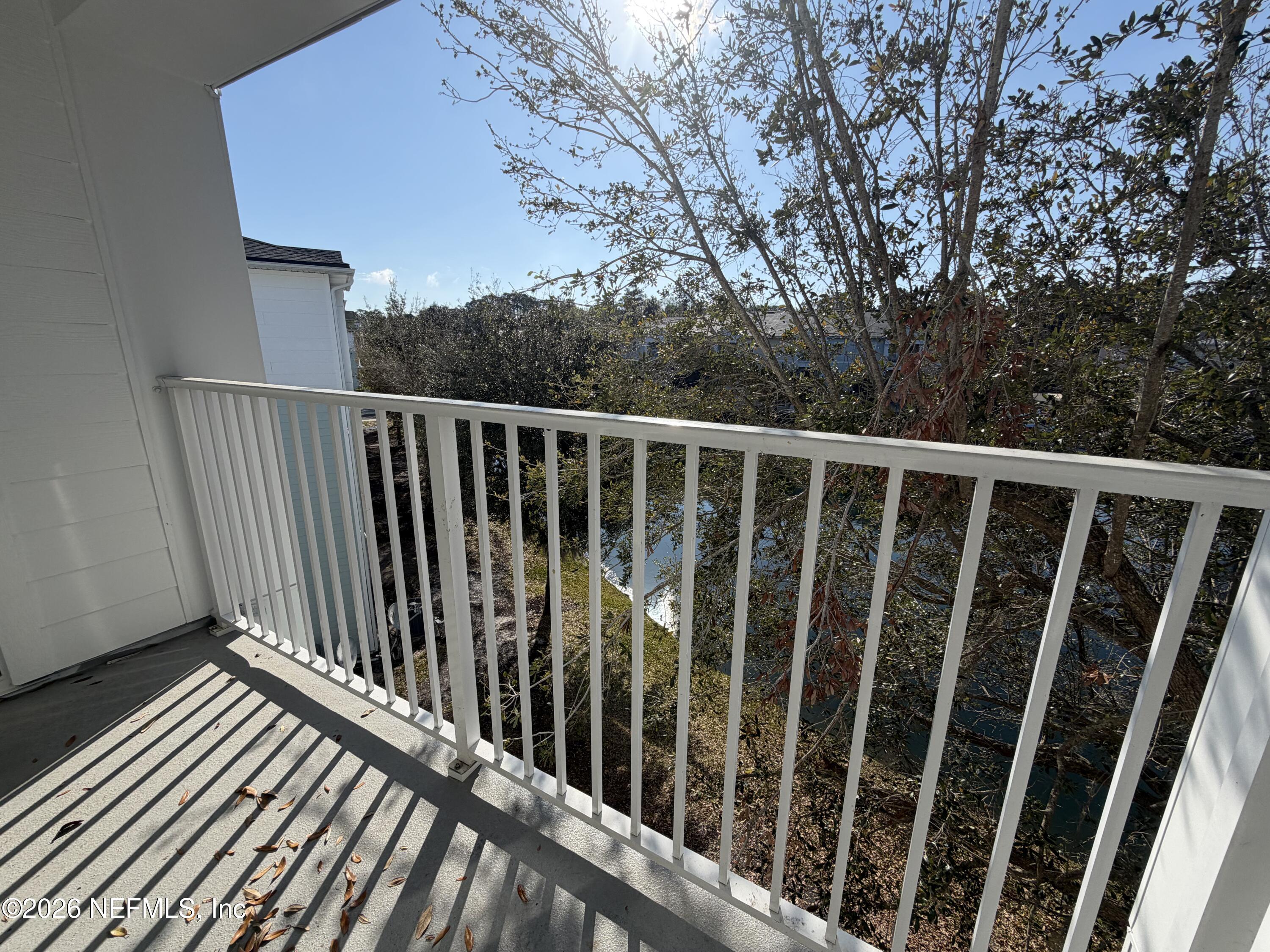 8218 Green Parrot Road, Unit 308 Jacksonville, FL 32256 - Photo 8 of 25 a view of balcony with wooden floor and fence